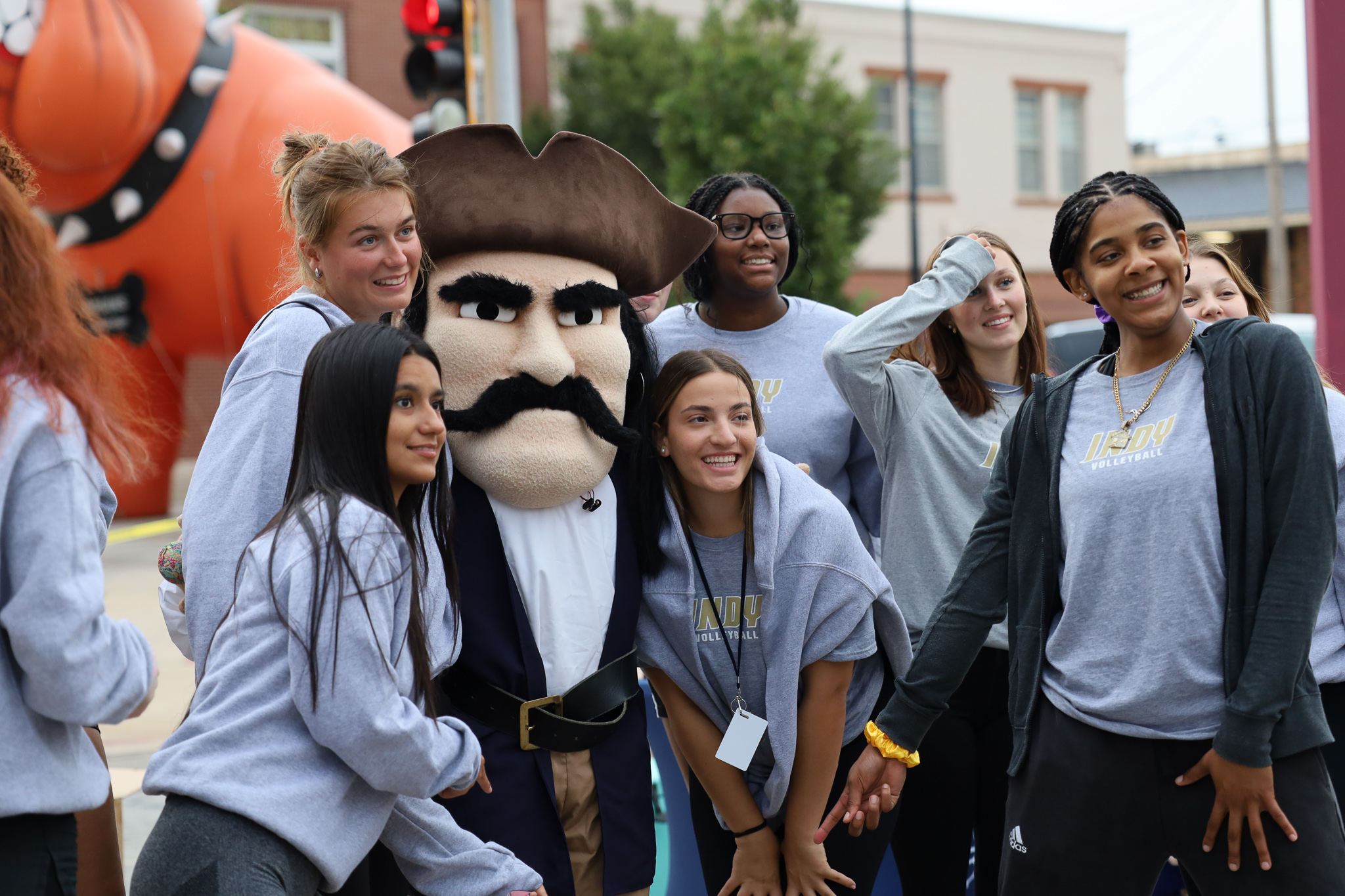students posing for a photo with pirate mascot