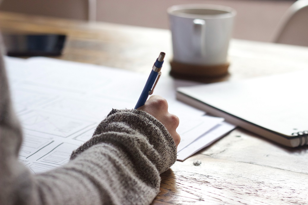 student writing in notes