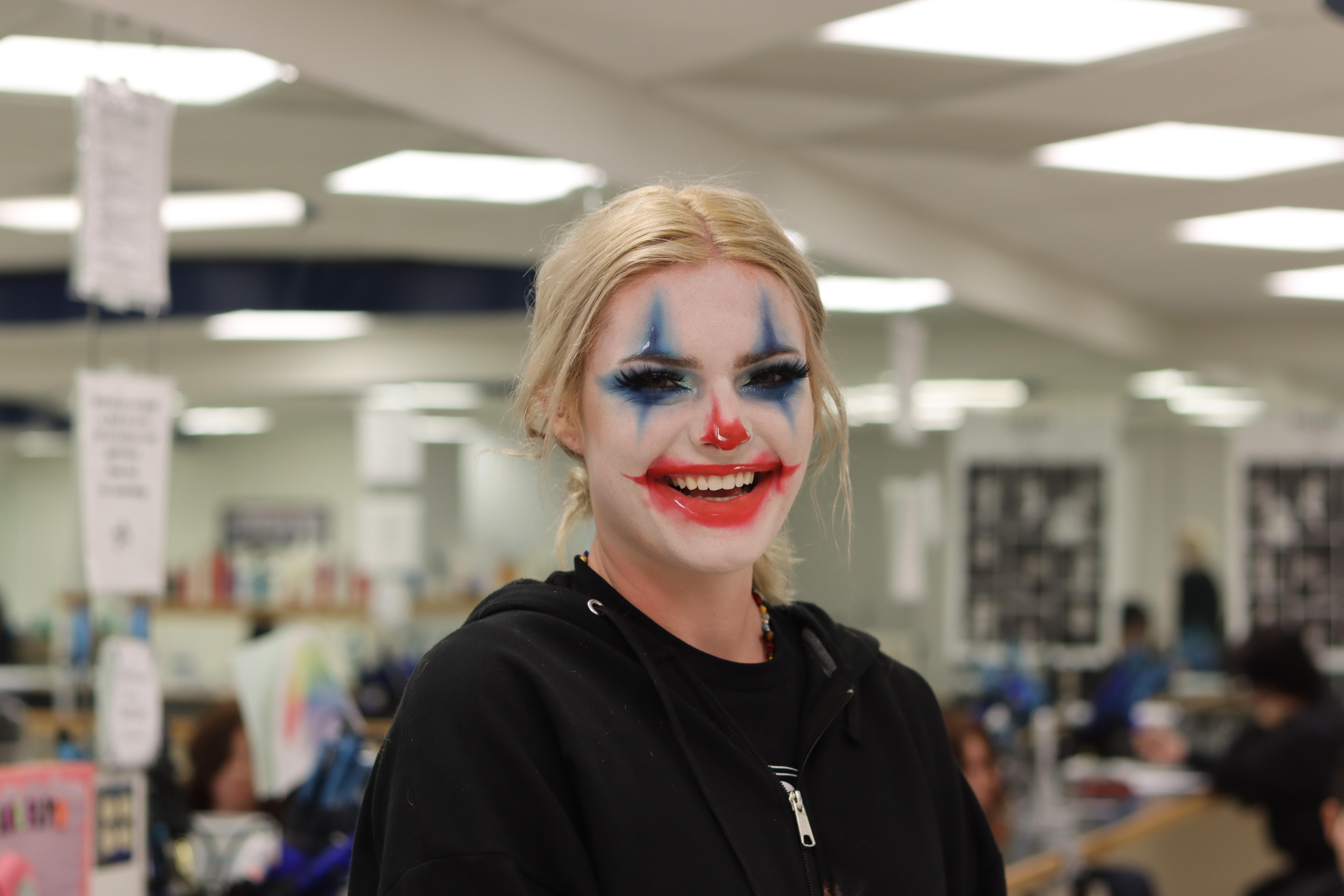 ICC cosmetology student with clown makeup on and smiling
