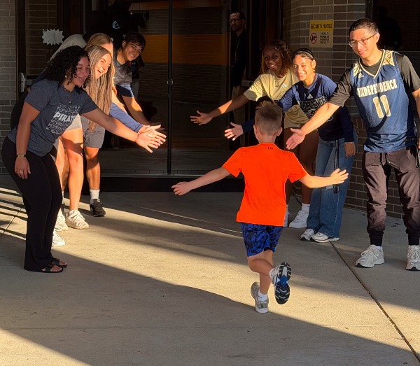 Students at giving high fives.